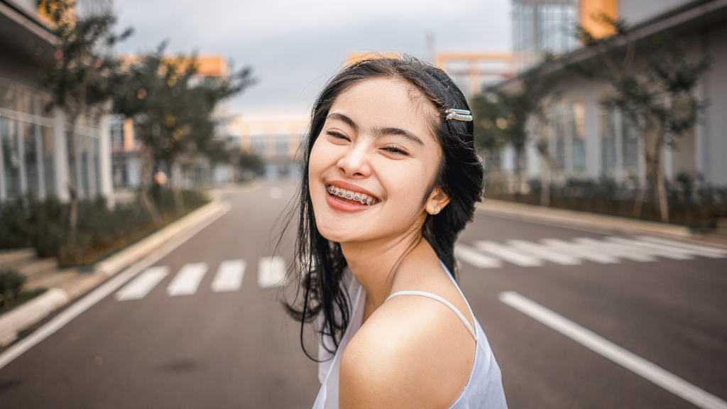 Young woman with braces smiling