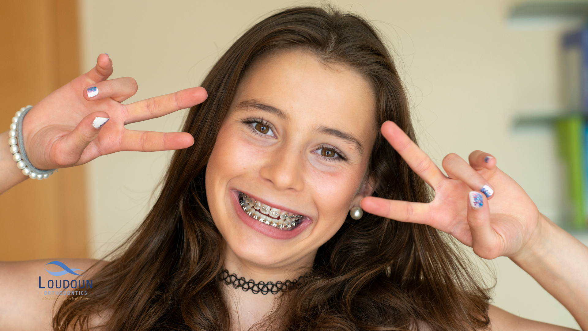 young girl with a perfect smile with braces smiling